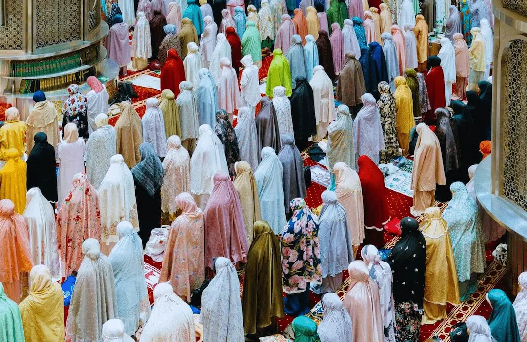 Some women in traditional clothes pray in the great mosque of Jakarta