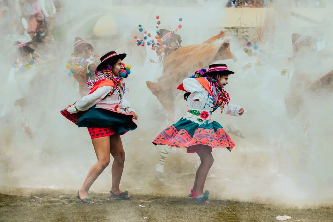 Two women dancin in a folk celebration in Bolivia