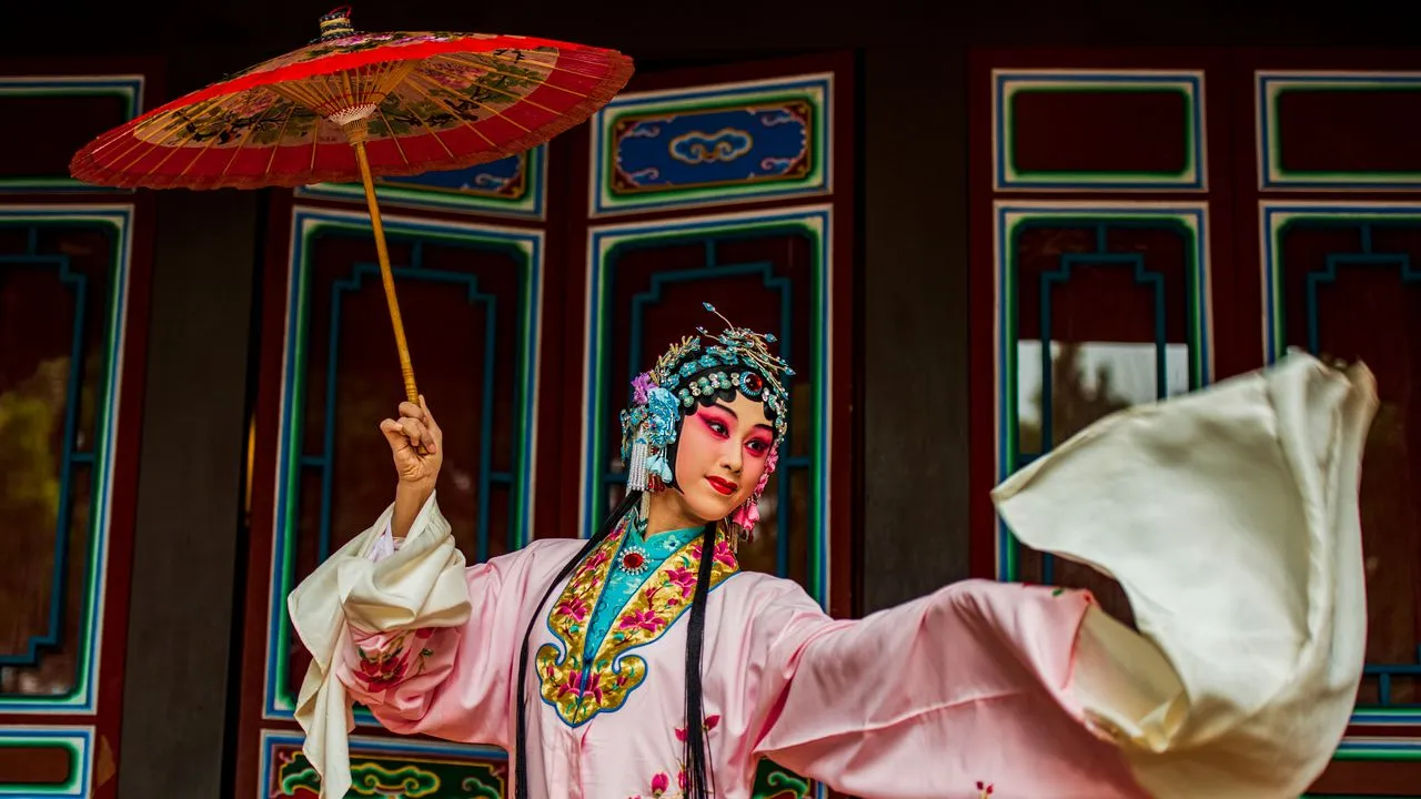 A chinese woman dreseed in opera traditional outfit dancing