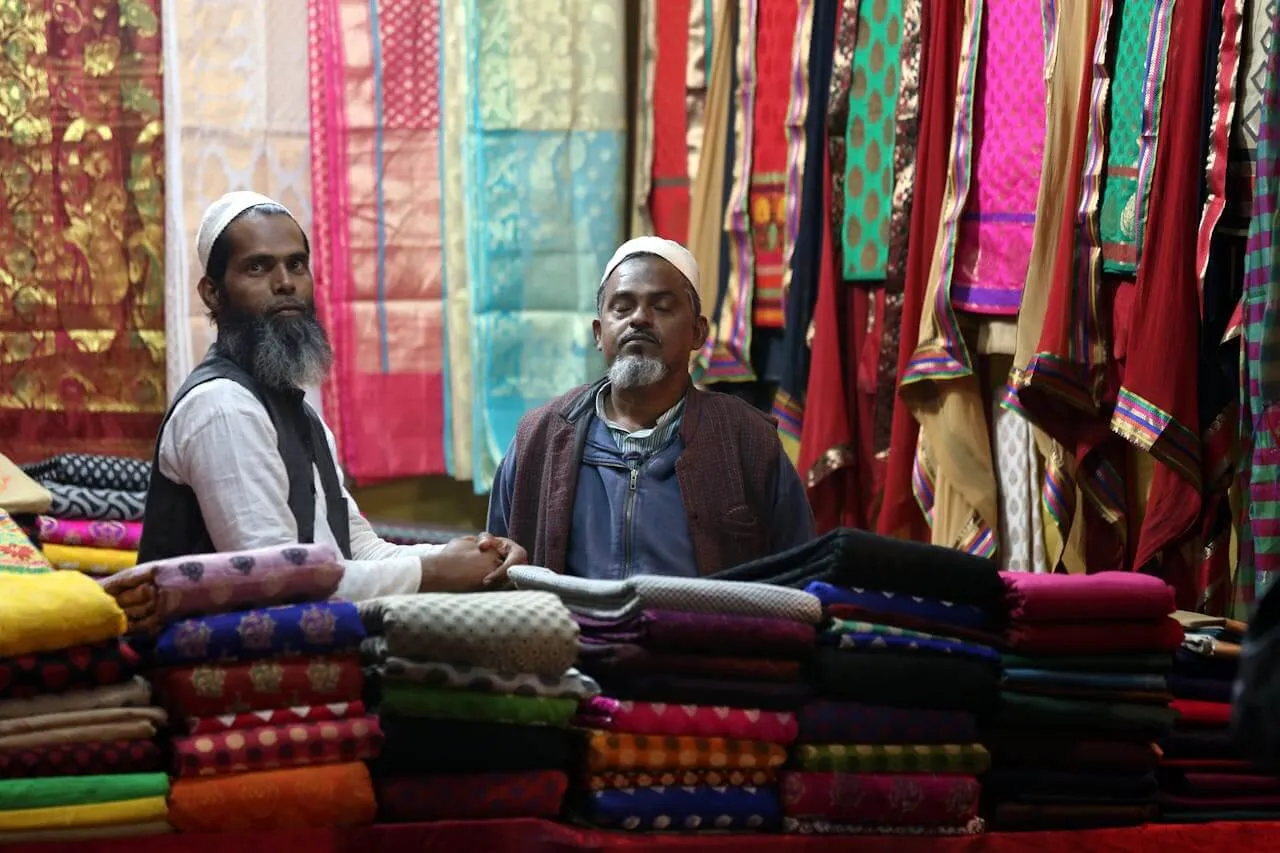 Two men selling clothes in a sop in Bangladesh